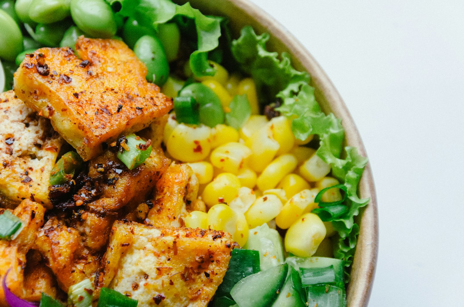 Tofu, almonds, kale and sesame seeds on a stone surface