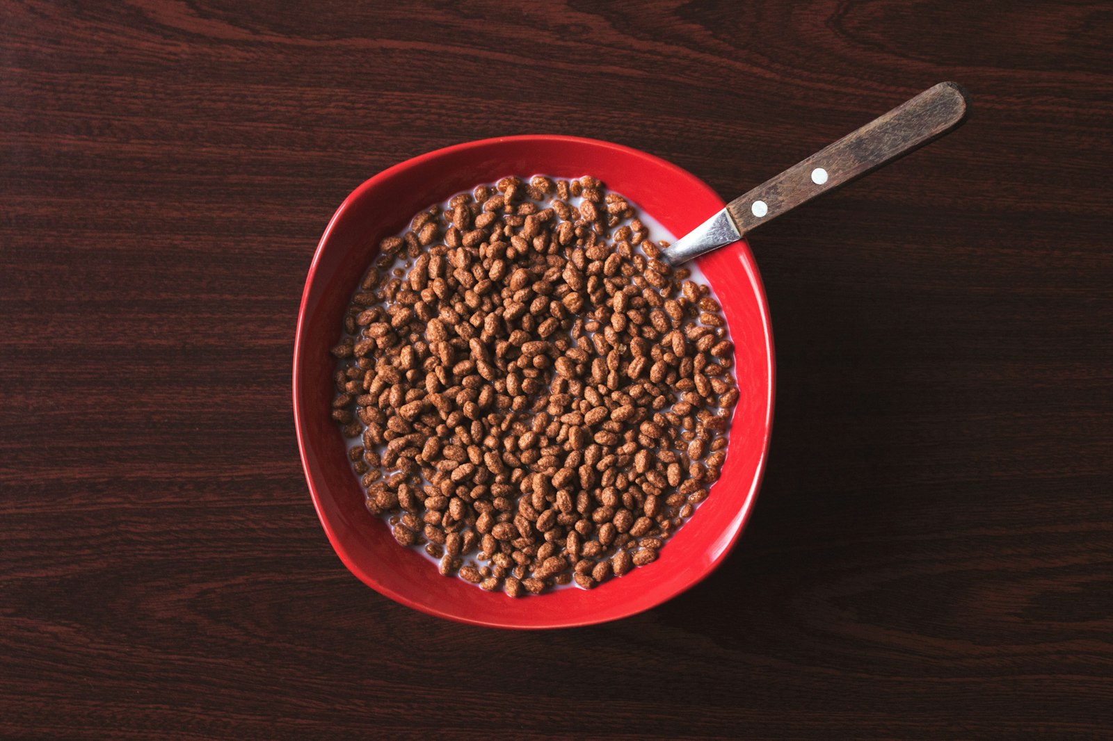 Lentils, spinach and red meat arranged on a dark worktop