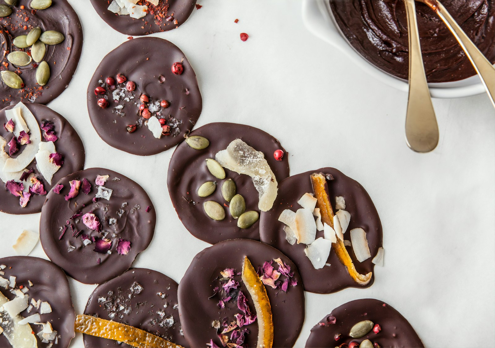 Pumpkin seeds, dark chocolate and almonds in small bowls